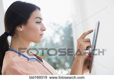 Nurse using digital tablet in hospital View Large Photo Image Stock Photo - Nurse using digital tablet in hospital. Fotosearch