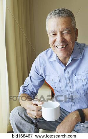 Stock Photo - Older Black man drinking coffee. Fotosearch