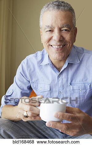 Stock Photo - Older Black man drinking coffee. Fotosearch