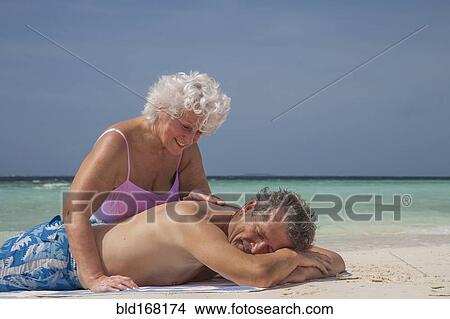 Older Caucasian couple relaxing on beach View Large Photo Image Picture - Older Caucasian couple relaxing on beach. Fotosearch