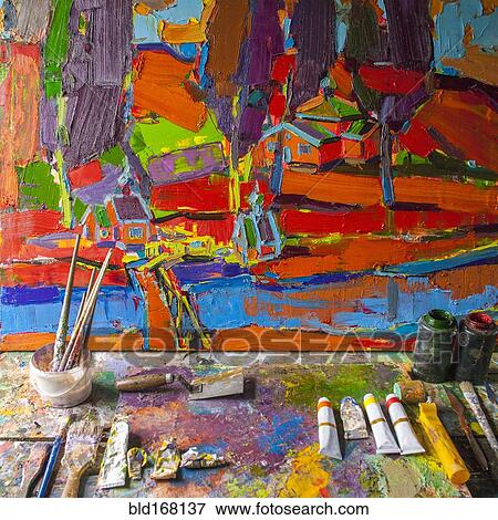 Painting on easel with paint and paintbrushes View Large Photo Image Stock Photo - Painting on easel with paint and paintbrushes. Fotosearch