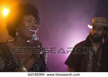 Picture - Singer and musician performing on stage. Fotosearch