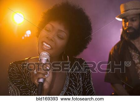 Singer and musician performing on stage View Large Photo Image Stock Image - Singer and musician performing on stage. Fotosearch
