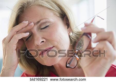 Stressed Caucasian woman rubbing forehead View Large Photo Image Stock Image - Stressed Caucasian woman rubbing forehead. Fotosearch