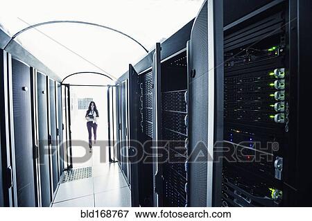 Technician walking in server room View Large Photo Image Stock Photo - Technician walking in server room. Fotosearch