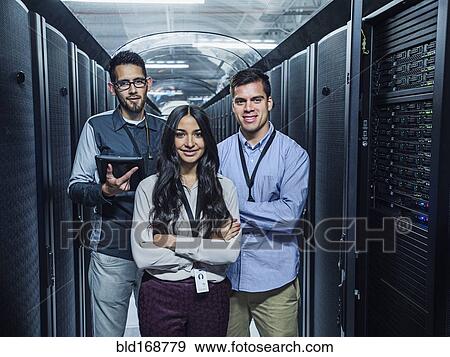Technicians smiling in server room View Large Photo Image Stock Photo - Technicians smiling in server room. Fotosearch