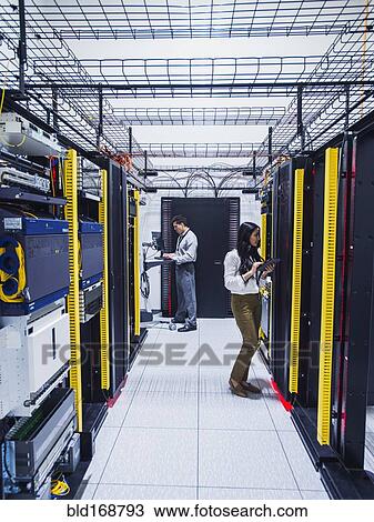 Technicians working in server room View Large Photo Image Stock Image - Technicians working in server room. Fotosearch