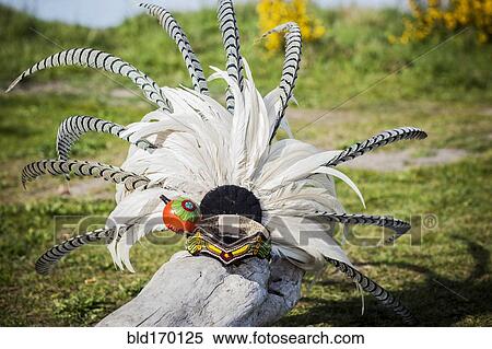 Stock Photography - Traditional headdress on wooden log. Fotosearch