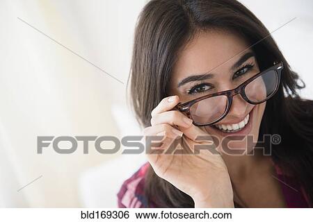 Stock Photograph - Woman peering over eyeglasses. Fotosearch