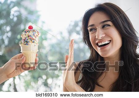 Woman refusing ice cream cone View Large Photo Image Stock Image - Woman refusing ice cream cone. Fotosearch