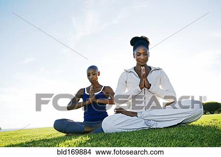 Women meditating in park View Large Photo Image Picture - Women meditating in park. Fotosearch