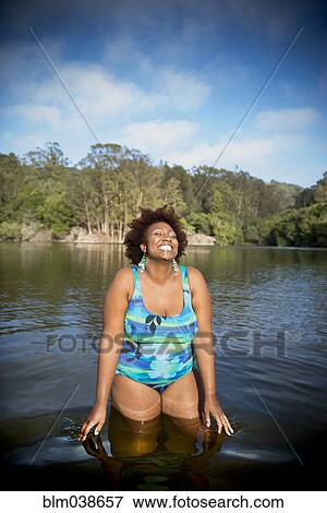 African American woman standing in rural lake View Large Photo Image Stock Photo - African American woman standing in rural lake. Fotosearch