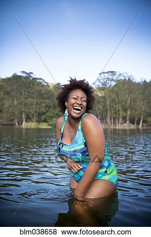 African American woman standing in rural lake View Large Photo Image Stock Photo - African American woman standing in rural lake. Fotosearch