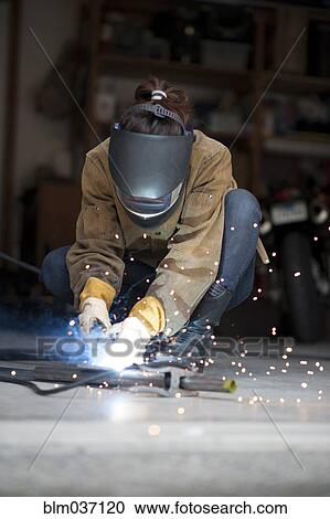 Artisan welding metal in workshop View Large Photo Image Stock Image - Artisan welding metal in workshop. Fotosearch