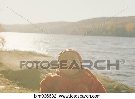 Stock Image - Asian baby girl at remote lake. Fotosearch