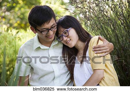 Asian couple hugging outdoors View Large Photo Image Stock Photography - Asian couple hugging outdoors. Fotosearch