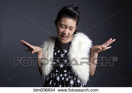 Asian girl dancing in furry vest View Large Photo Image Picture - Asian girl dancing in furry vest. Fotosearch