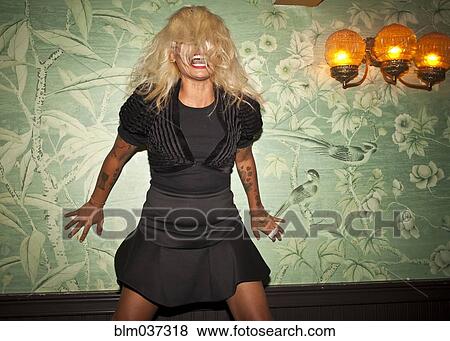 Stock Photo - Asian woman dancing at party. Fotosearch