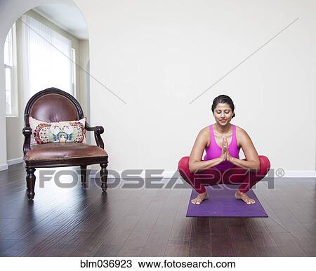 Asian woman practicing yoga in living room View Large Photo Image Stock Image - Asian woman practicing yoga in living room. Fotosearch