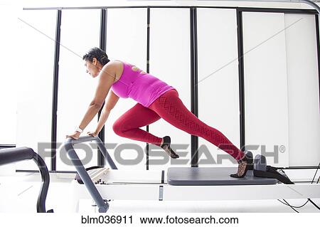 Asian woman using exercise machine in gymnasium View Large Photo Image Stock Image - Asian woman using exercise machine in gymnasium. Fotosearch