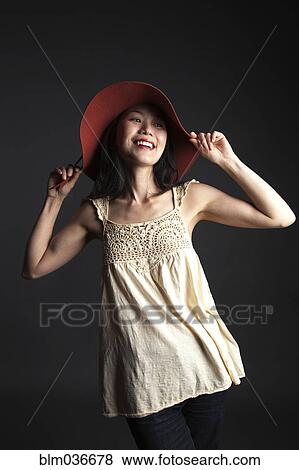 Asian woman wearing red hat View Large Photo Image Stock Photo - Asian woman wearing red hat. Fotosearch
