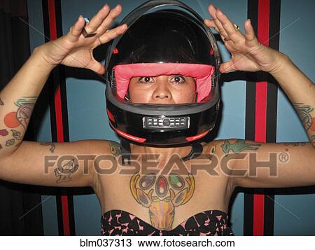 Asian woman with tattoos wearing motorcycle helmet View Large Photo Image Stock Image - Asian woman with tattoos wearing motorcycle helmet. Fotosearch