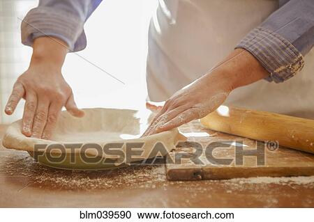 Baker pressing pie dough in dish View Large Photo Image Stock Image - Baker pressing pie dough in dish. Fotosearch