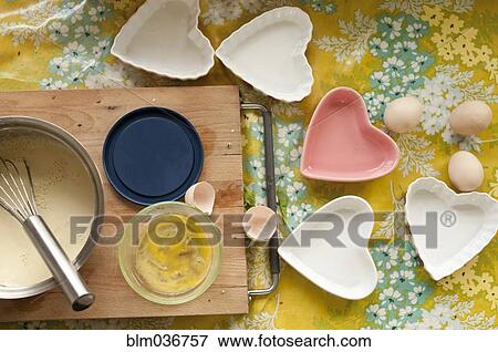 Baking tools and heart shape trays on table View Large Photo Image Stock Photo - Baking tools and heart shape trays on table. Fotosearch