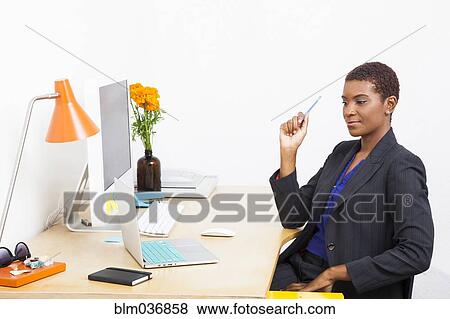 Black businesswoman using laptop at office desk View Large Photo Image Stock Photo - Black businesswoman using laptop at office desk. Fotosearch