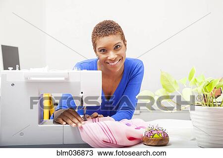Black dressmaker using sewing machine View Large Photo Image Stock Image - Black dressmaker using sewing machine. Fotosearch