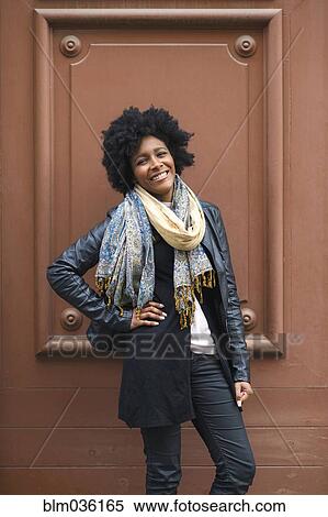 Black woman smiling near frame in wall View Large Photo Image Stock Photography - Black woman smiling near frame in wall. Fotosearch