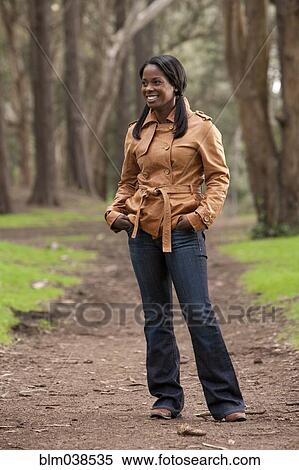Black woman standing on dirt path View Large Photo Image Stock Photography - Black woman standing on dirt path. Fotosearch