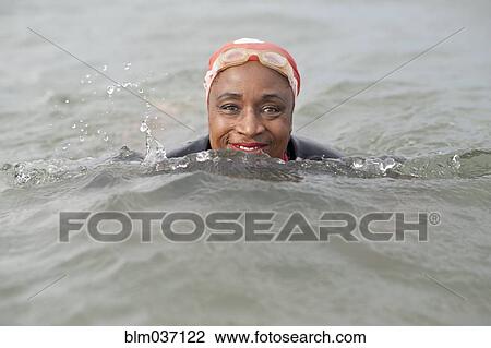 Black woman swimming in ocean View Large Photo Image Stock Image - Black woman swimming in ocean. Fotosearch
