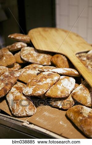 Bread peel on pile of homemade loaves View Large Photo Image Stock Photography - Bread peel on pile of homemade loaves. Fotosearch