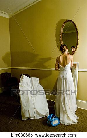 Bride adjusting makeup in mirror View Large Photo Image Stock Photography - Bride adjusting makeup in mirror. Fotosearch