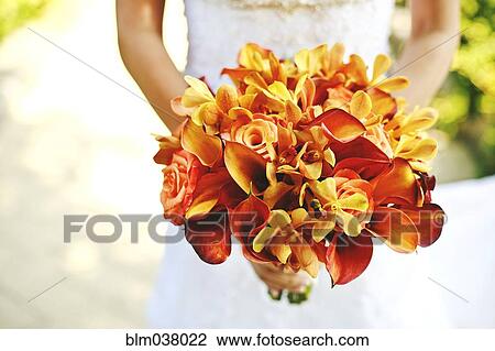 Stock Image - Bride carrying bouquet of flowers. Fotosearch
