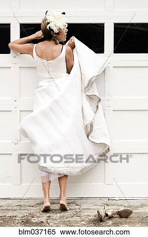 Bride peeking inside garage window View Large Photo Image Stock Photography - Bride peeking inside garage window. Fotosearch