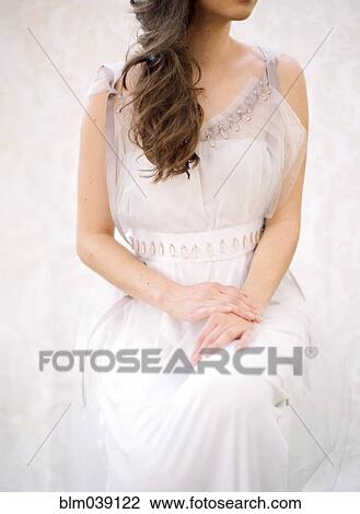 Stock Image - Bride sitting in wedding dress. Fotosearch