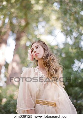 Stock Photography - Bride walking under trees. Fotosearch