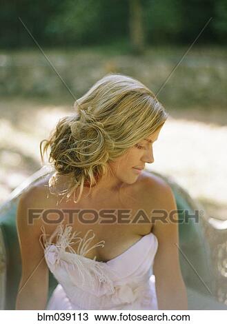 Bride wearing wedding dress on sofa in backyard View Large Photo Image Stock Image - Bride wearing wedding dress on sofa in backyard. Fotosearch