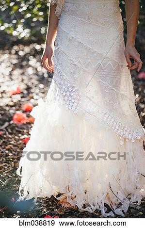 Bride wearing wedding gown in garden View Large Photo Image Stock Photo - Bride wearing wedding gown in garden. Fotosearch