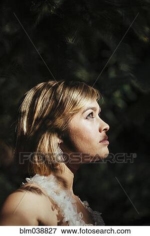 Bride wearing wedding gown in garden View Large Photo Image Stock Photo - Bride wearing wedding gown in garden. Fotosearch