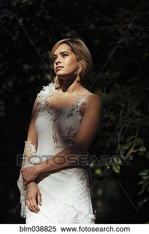 Bride wearing wedding gown in garden View Large Photo Image Stock Photography - Bride wearing wedding gown in garden. Fotosearch