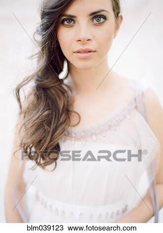 Stock Image - Bride with curled hair in wedding dress. Fotosearch