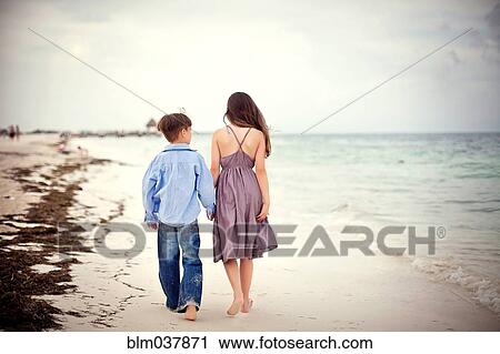 Brother and sister walking on beach View Large Photo Image Stock Image - Brother and sister walking on beach. Fotosearch