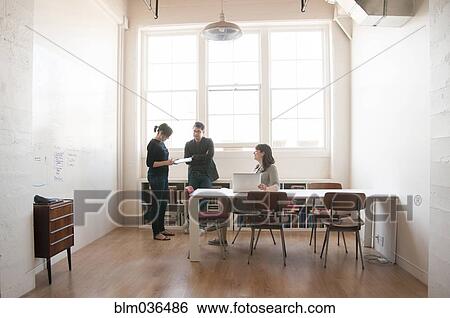 Stock Photograph - Business people talking in office. Fotosearch