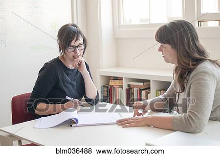 Businesswomen working together in office View Large Photo Image Stock Photo - Businesswomen working together in office. Fotosearch