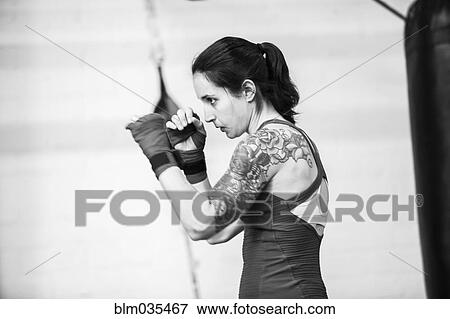 Stock Photo - Caucasian boxer training in gymnasium. Fotosearch