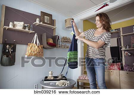 Caucasian business owner arranging items in store View Large Photo Image Stock Photograph - Caucasian business owner arranging items in store. Fotosearch