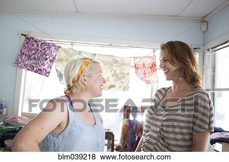 Caucasian business owner assisting customer View Large Photo Image Stock Photo - Caucasian business owner assisting customer. Fotosearch